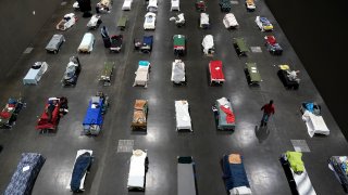 Beds fill the San Diego Convention Center for the homeless