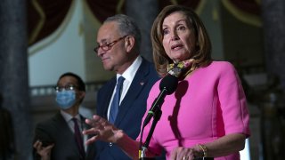 Senate Minority Leader Chuck Schumer, center, listens as House Speaker Nancy Pelosi speaks to members of the media following a meeting at the U.S. Capitol in Washington, D.C., Aug. 7, 2020.