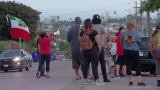 A group gathers to protest U.S. Border Patrol's presence in the Grant Hill neighborhood.