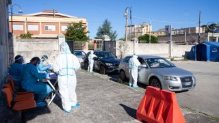 A team of nurses who swab inside the cars of people who have returned from vacation on August 20, 2020 in Bari, Italy.