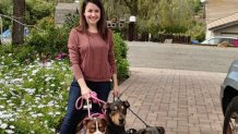 El Cajon resident Linda Miller poses with her trio of dogs.