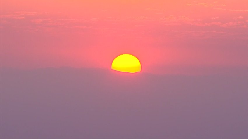 A sunrise as a wildfire burns in East County