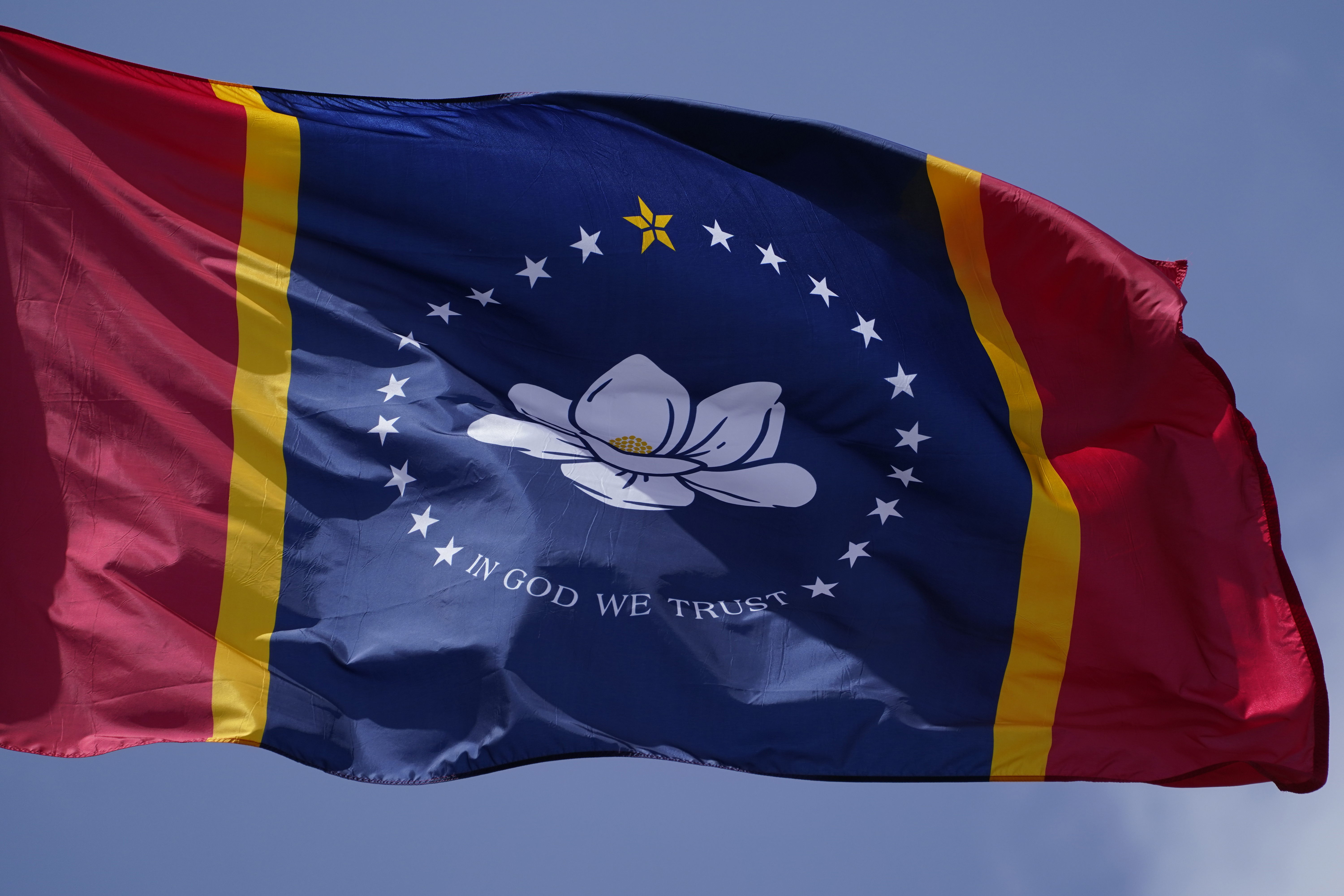 In this Sept. 2, 2020, file photo, the magnolia centered banner chosen by the Mississippi State Flag Commission flies outside the Old State Capitol Museum in downtown Jackson, Mississippi.