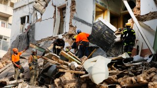 Chilean and Lebanese rescuers search in the rubble of a building that was collapsed in last month's massive explosion, after getting signals there may be a survivor under the rubble, in Beirut, Lebanon, Thursday, Sept. 3, 2020. Hopes were raised after the dog of a Chilean search and rescue team touring Gemmayzeh street, one of the hardest-hit in Beirut, ran toward the collapsed building.