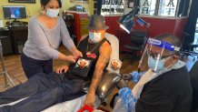 Marco Arellano getting a tattoo of his father who passed away to COVID-19.