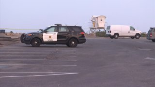 Investigators assess the scene of a shooting homicide in Ocean Beach on Tuesday, Sept. 15, 2020.