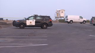 Investigators assess the scene of a shooting homicide in Ocean Beach on Tuesday, Sept. 15, 2020.