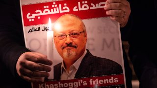 A demonstrator holds a poster picturing Saudi journalist Jamal Khashoggi