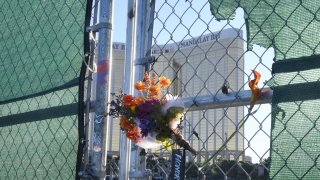 Flowers and a sign reading "HONOR 58" hang on a fence outside the Las Vegas Village across from Mandalay Bay Resort and Casino as a tribute to those killed almost two years ago in a massacre at the site on September 30, 2019 in Las Vegas, Nevada. On October 1, 2017, a gunman opened fire from the 32nd floor of Mandalay Bay on the Route 91 Harvest country music festival in Las Vegas killing 58 people and injuring more than 800 in the deadliest mass shooting event in U.S. history.