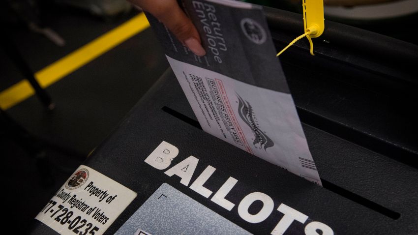 A woman casts her ballot.
