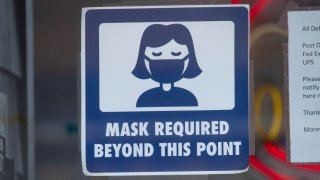a sign asking people to wear a mask