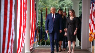 President Donald Trump, first lady Melania Trump and 7th U.S. Circuit Court Judge Amy Coney Barrett, 48, walk into the Rose Garden before Trump announces Barrett as his nominee to the Supreme Court at the White House September 26, 2020 in Washington, DC.