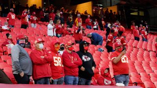 In this Thursday, Sept. 10, 2020, file photo, fans stand for a presentation on social justice before an NFL football game between the Kansas City Chiefs and the Houston Texans in Kansas City, Mo.