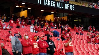 In this Thursday, Sept. 10, 2020, file photo, fans stand for a presentation on social justice before an NFL football game between the Kansas City Chiefs and the Houston Texans in Kansas City, Mo.