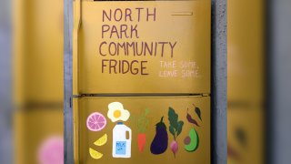 a yellow community fridge in North Park