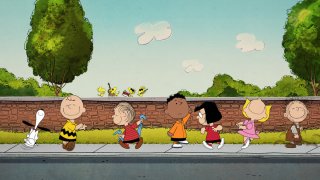 “Peanuts” characters walk along sidewalk