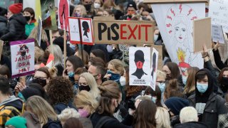 Women's rights activists hold placards during a protest