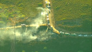 Firefighters taking control of a small brush fire burning in Descanso.