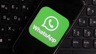 The WhatsApp application logo launched on a mobile phone.