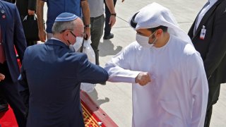 Israeli National Security Advisor Meir Ben-Shabbat elbow bumps with an Emirati official ahead of boarding the plane before leaving Abu Dhabi, United Arab Emirates September 1, 2020.