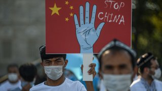 Supporters of China's Muslim Uyghur minority wave flags of East Turkestan and hold placards as they gather at the Beyazid square on October 1, 2020 during a demonstration to protest China's Uighur treatment in Istanbul.