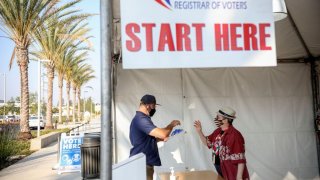 A voter signs-in to cast his ballot at the San Diego County Registrar of Voters