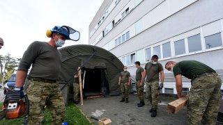Soldiers of the Croatian Army set up tents in front of the Clinical Hospital Center Zagreb, the largest hospital in Zagreb, on October 9, 2020. After a sudden outbreak of coronavirus infection was recorded in Croatia in the last two days, the authorities decided to set up tents in which triage would be performed in the event of an increased number of people in need of hospital treatment.
