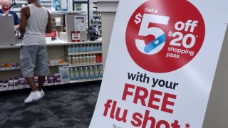 A sign advertising free flu shots is seen at a CVS Pharmacy