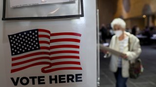 A voter walks towards a booth to fill out her ballot during the in-person early voting at a polling station in Lincoln Center in New York, the United States, Oct. 24, 2020. Early voting began across New York State on Saturday, offering voters nine days to cast their ballots prior to Election Day.