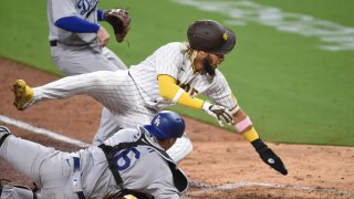 SAN DIEGO, CA – AUGUST 3: Fernando Tatis Jr. #23 of the San Diego Padres collides with Will Smith #16 of the Los Angeles Dodgers as he’s tagged out at the plate during the seventh inning of a baseball game at Petco Park August 3, 2020 in San Diego, California. (Photo by Denis Poroy/Getty Images)