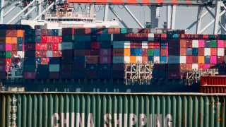 Shipping containers from China and other Asian countries are unloaded at the Port of Los Angeles as the trade war continues between China and the US, in Long Beach, California on September 14, 2019. –