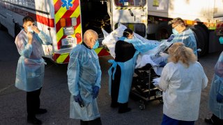 Bodies are moved to refrigerated trailers, deployed during a surge of coronavirus disease (COVID-19) deaths, outside the County of El Paso Medical Examiners Office in El Paso, Texas, U.S. November 16, 2020.