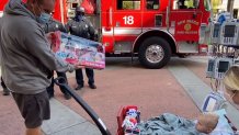 The little boy was gifted with a replica fire engine.