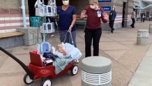 Beauden Baumkirchner, 3, waves at San Diego firefighters outside of the hospital.