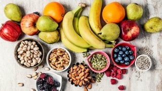 Variety of fruits and nuts on gray background