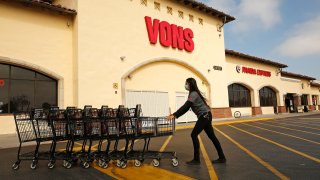TORRANCE, CA – APRIL 27: Sofia Angeles collects shopping carts to be returned into the store at the Vons located at 24325 Crenshaw Blvd in Torrance. Doors to the store opened at 6 a.m. for seniors and at-risk shoppers due to the Coronavirus and at 7 a.m. for regular customers. Most of the team arrives at 5 a.m. to stock the shelves with product, sanitize the location for staff and shoppers, and picker/shoppers begin to collect items for .com home delivery shoppers. Vendors arriving throughout the morning must read a checklist of warnings, sign in and they must wear face covering. Vons on Monday, April 27, 2020 in Torrance, CA. (Al Seib / Los Angeles Times via Getty Images)