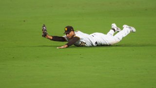 SAN DIEGO, CA – SEPTEMBER 15: Trent Grisham #2 of the San Diego Padres makes a diving catch in the top of the fifth inning against the Los Angeles Dodgers at PETCO Park on September 15, 2020 in San Diego, California. (Photo by Matt Thomas/San Diego Padres/Getty Images)