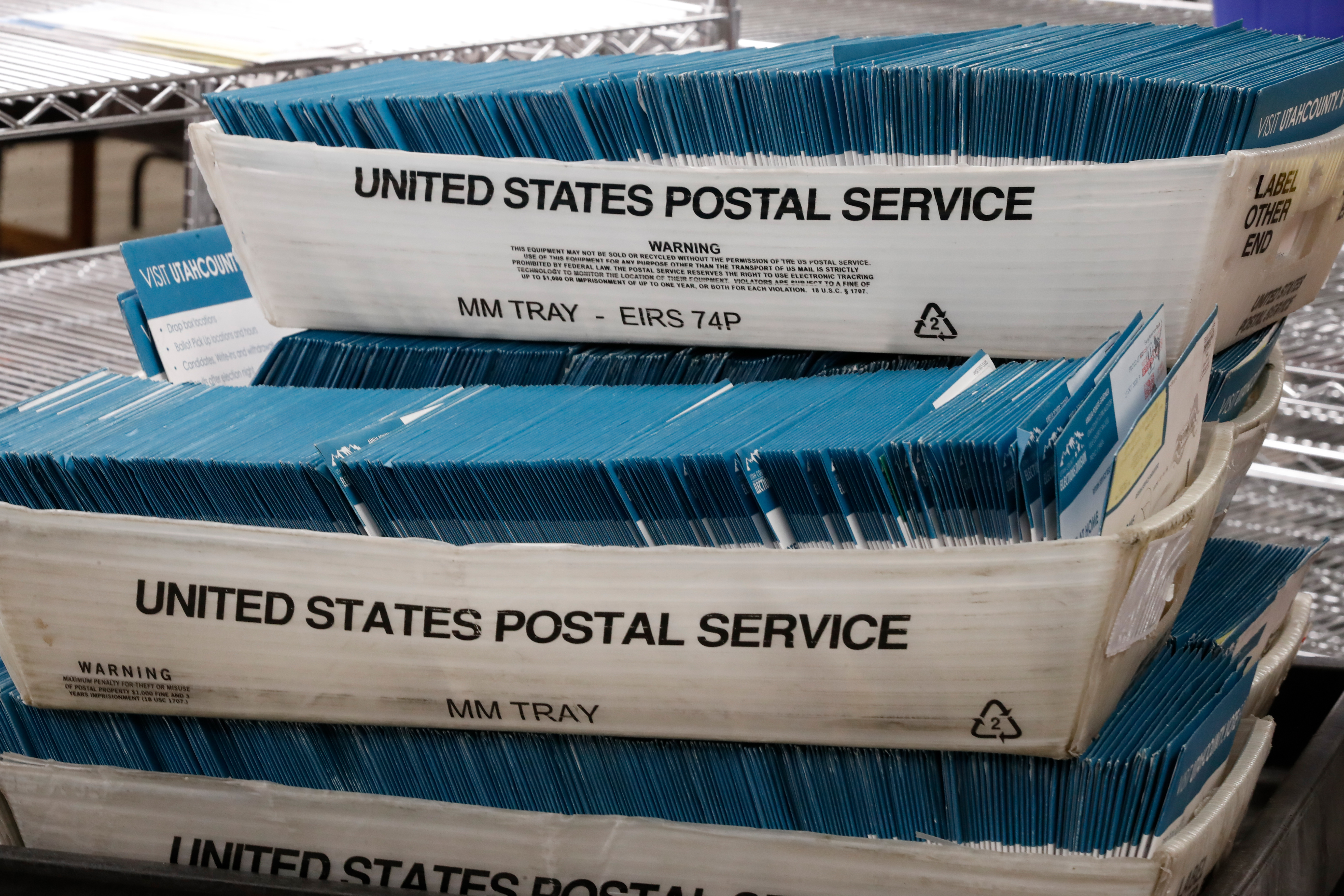 Returned ballots, where the voter could not be located, are stacked in United States Postal Service containers