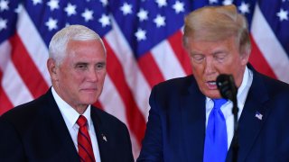 US Vice President Mike Pence (L) listens as US President Donald Trump speaks during election night in the East Room of the White House in Washington, DC, early on November 4, 2020.