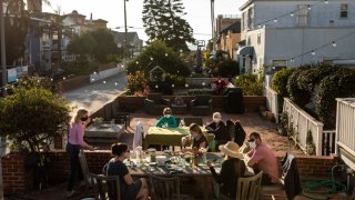 HERMOSA BEACH, CA – NOVEMBER 26: Grandmothers Ann Anderson, in green and G.G., in purple, had their own table, while celebrating with their children, Teri and Joe Anderson, right and grandchildren, Kelsey, left, in purple, Jenny and Emma, center, with some dessert, following their Thanksgiving dinner outside, 17th Street, in Hermosa Beach, CA, Thursday, Nov. 26, 2020. (Jay L. Clendenin / Los Angeles Times via Getty Images)