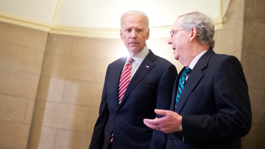 Vice President Joe Biden, left, and Senate Majority Leader Mitch McConnell, R-Ky., make their way to the House floor for President Obama's State of the Union address, January 12, 2016.
