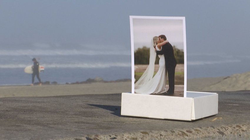 A picture of a bride and groom set in front of a beach