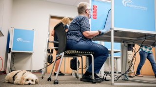 A voter casts his ballot at the San Diego County Registrar of Voters.