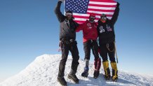 Kionte Storey and his friends celebrate the completion of their trek up Mount Vinson in Antarctica.