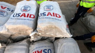 Personnel check humanitarian aid supplies after 60 tons of aid from USAID.
