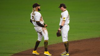 SAN DIEGO, CA – SEPTEMBER 18: Fernando Tatis Jr #23 and Jake Cronenworth #9 of the San Diego Padres celebrate after defeating the Seattle Mariners at PETCO Park on September 18, 2020 in San Diego, California. The game was moved to San Diego due to air quality concerns in Seattle from the wildfires. (Photo by Matt Thomas/San Diego Padres/Getty Images)