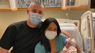 Nick and Melissa Hawke with their newborn, Delmar.