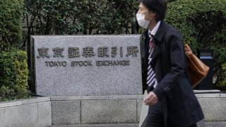 A man walks past the Tokyo Stock Exchange (TSE), operated by Japan Exchange Group Inc. (JPX), in Tokyo, Japan, on Monday, Nov. 30, 2020.