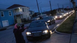 Residents line up in their vehicles to enter a warming center and shelter after record-breaking winter temperatures, as local media reports most residents are without electricity, in Galveston, Texas, U.S., February 17, 2021.