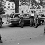 The Arkansas National Guard escorts Carlotta Walls LaNier and a fellow member of the Little Rock Nine on the grounds of Little Rock Central High School, September 1957.